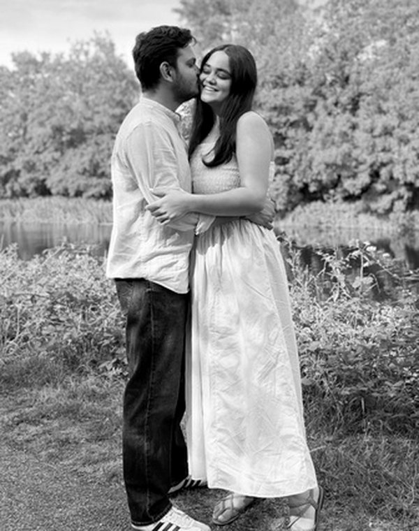Raj kissing Lavina by the river